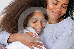 Caring african american single mother hugging teenage daughter, motherhood concept