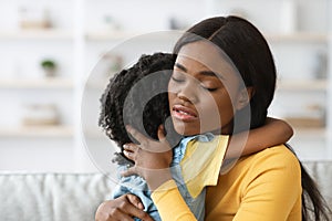 Caring African American Woman Hugging Little Daughter, Comforting Her Upset Child