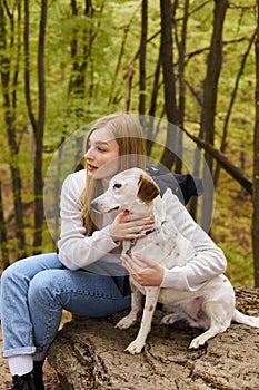 Caring blonde woman hugging her dog