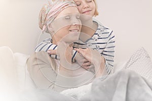 Child embracing mother with leukemia