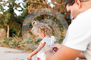 Caring dad gets daughter ready for walk standing outside  loving father buttoning cute girl  daddys little princess  spending time