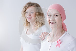 Caring daughter supporting cancer mother