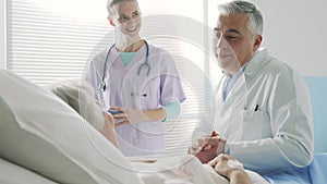 Caring doctor talking with a senior patient and supporting her