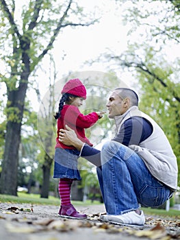 Caring Father With Daughter In Park