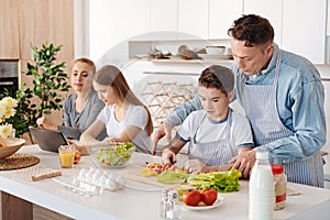 Caring father teching his son to cook