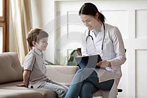 Caring female doctor consult little boy patient in hospital