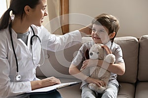 Caring female doctor examine little boy patient in hospital