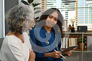 Caring female doctor explaining the medical results to the senior woman during home visit. Home health care service