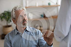 Caring female nurse support elderly man in hospital