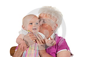 Caring granny kissing her grandchild