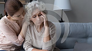 Caring grownup daughter support comfort upset old mother