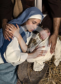 Caring hands at Christmas nativity