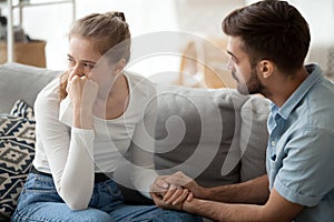 Caring husband hold wife hand making peace after fight