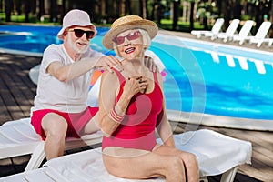 Caring husband putting protection sun cream on his wife