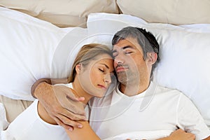 Caring lovers sleeping lying on the bed