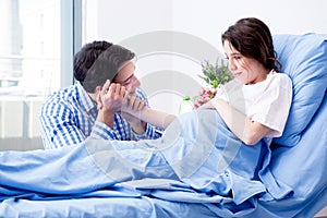 The caring loving husband visiting pregnant wife in hospital