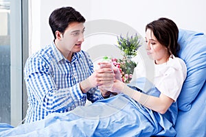 The caring loving husband visiting pregnant wife in hospital