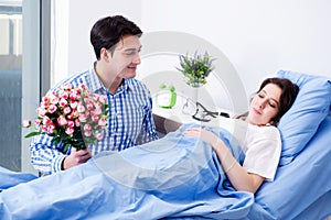 The caring loving husband visiting pregnant wife in hospital