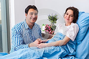 The caring loving husband visiting pregnant wife in hospital