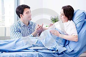 The caring loving husband visiting pregnant wife in hospital