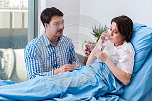 The caring loving husband visiting pregnant wife in hospital