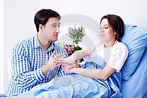 The caring loving husband visiting pregnant wife in hospital