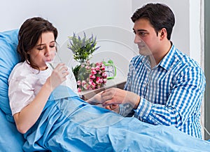 Caring loving husband visiting pregnant wife in hospital