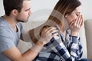 Caring man comfort crying wife making peace after fight photo
