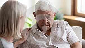 Caring mature woman comfort support upset elderly man