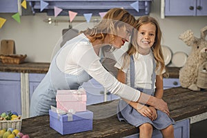 Pleased mom showing love to daughter photo