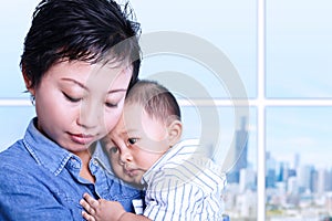 Caring mother nursing baby in office