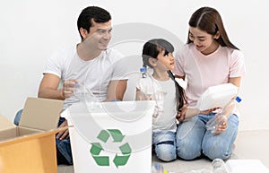 Caring about nature. Smiling multiethnic family sibling  having fun sorting segregating household waste together at home.Lifestyle