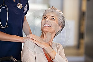 Caring nurse comforting old woman