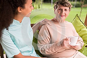 Caring nurse and elder woman photo