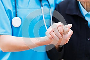 Caring Nurse holding Elderly Hands