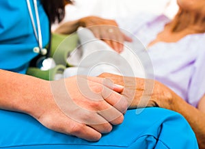 Caring Nurse Holding Hands photo