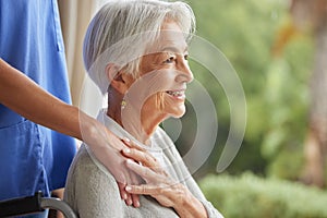 Caring nurse supporting senior woman in an old age home with copyspace. Smiling elderly woman feeling happy and touching