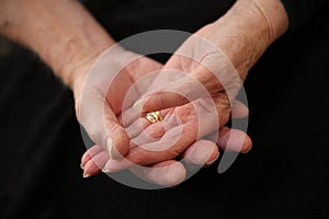 Caring older woman and mans hands