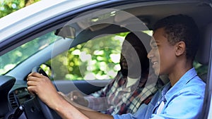 Caring parent teaching son how to drive car, spending time together, family