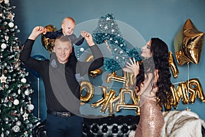 Caring parents and adorable baby feeling excited for holidays