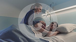 Caring woman assisting her friend with cancer at the hospital