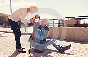 Caring woman offering help to a fallen man