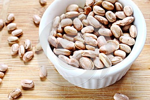 Carioca beans. Bowl with grains on the wooden board