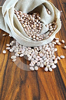Carioca beans. Brazilian grains in a jute fabric on the rustic table.