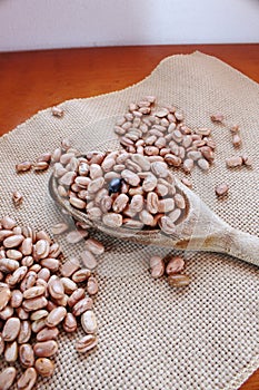 Carioca beans spoon on the jute fabric. Brazilian grains photo