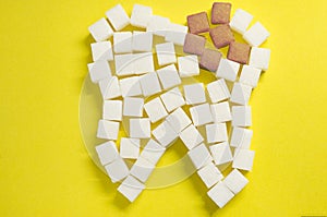 The carious tooth of sugar cubes of refined sugar, preventing tooth decay, caring for the health of your teeth