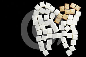 The carious tooth of sugar cubes of refined sugar, preventing tooth decay, caring for the health of your teeth