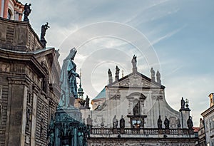 Carlo Cuarto monument to Charles IV in the background Church of St. Salvator. Prague at sunset. Antique small church with statues photo