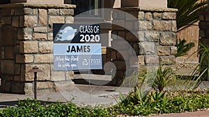 Carlsbad, CA / USA - May 11, 2020: A yard sign celebrates a 2020 graduate during pandemic shutdown.