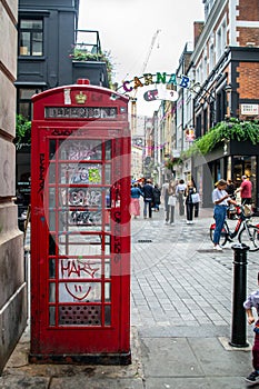 CARNABY STREET, LONDON, ENGLAND- 4 September 2021: Red phone box in Carnaby Street in London, England